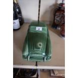 A 20th century green glazed ceramic model of a sports car,