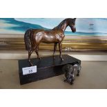 A bronze model of a horse, raised on a wooden plinth base, together with W M F pewter dog.