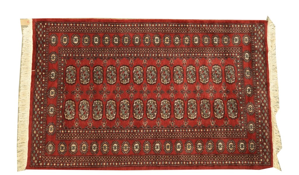 A Bokhara style rug Of rectangular form with tasselled edging,