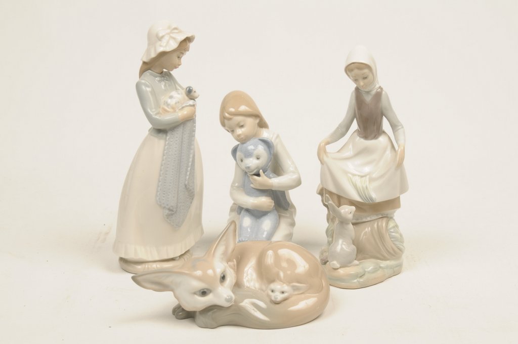 A collection of Lladro and Nao figures To include a Lladro seated fox and cub and a figure of girl