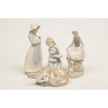 A collection of Lladro and Nao figures To include a Lladro seated fox and cub and a figure of girl