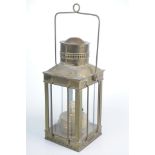 A brass oil lamp In the form of a four glass lantern with pierced funnel top,