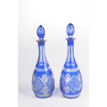 A pair of early 20th Century Bohemian blue overlay glass decanters Each of pear form rising to a