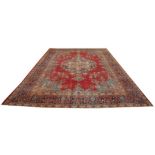 A Persian Kashan style medallion rug The large rug on a predominately ruby red ground with central