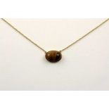 COLLIER, 750/ooo Gelbgold, zentrales Tigeraugencabochon, 4,8g, L 40 22.00 % buyer's premium on the