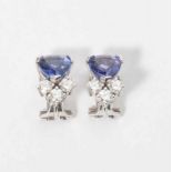 A pair of 18 carat white gold ear clips with diamonds and tanzanite 20th century Each set with an