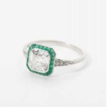 A platinum Art Deco ring with diamonds and emeralds Circa 1925 The ring set with a central carre-