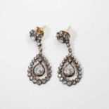 A pair of 14 carat gold and silver ear studs with diamonds The Netherlands, early 20th century The