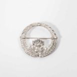 An 18 carat white gold Art Deco brooch with diamonds Paris, circa 1920 The circular brooch set with