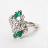 An 18 carat white gold ring with diamonds and emeralds Circa 1970 The white gold ring set with