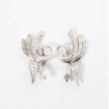 A pair of platinum Art Deco ear clips with diamonds Circa 1925 The platinum ear clips scroll-shaped