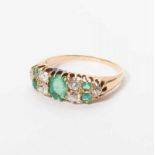 An antique 18 carat gold ring with diamonds and emeralds Late 19th century The gold ring set with a