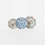 A Chinese blue and white plate and two famille rose plates Kangxi period (1662-1722) and Qianlong