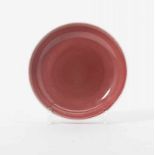 A Chinese copper-red-glazed dish 20th century Covered in a glaze of a soft red glaze thinning to