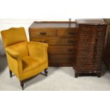 A reproduction mahogany six-drawer bow-front chest, an oak two-over-three chest of drawers,