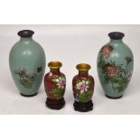 Two Japanese small cloisonné baluster vases, terracotta ground decorated with pink magnolia blossom,