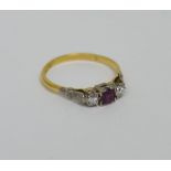 An 18ct yellow gold and platinum ring set with central pink stone flanked either side by a diamond,