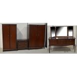 A suite of Stag bedroom furniture to include a triple wardrobe, a two-door wardrobe,