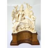 An early 20th century Indian ivory figural group depicting the Hindu god Durga atop a lion