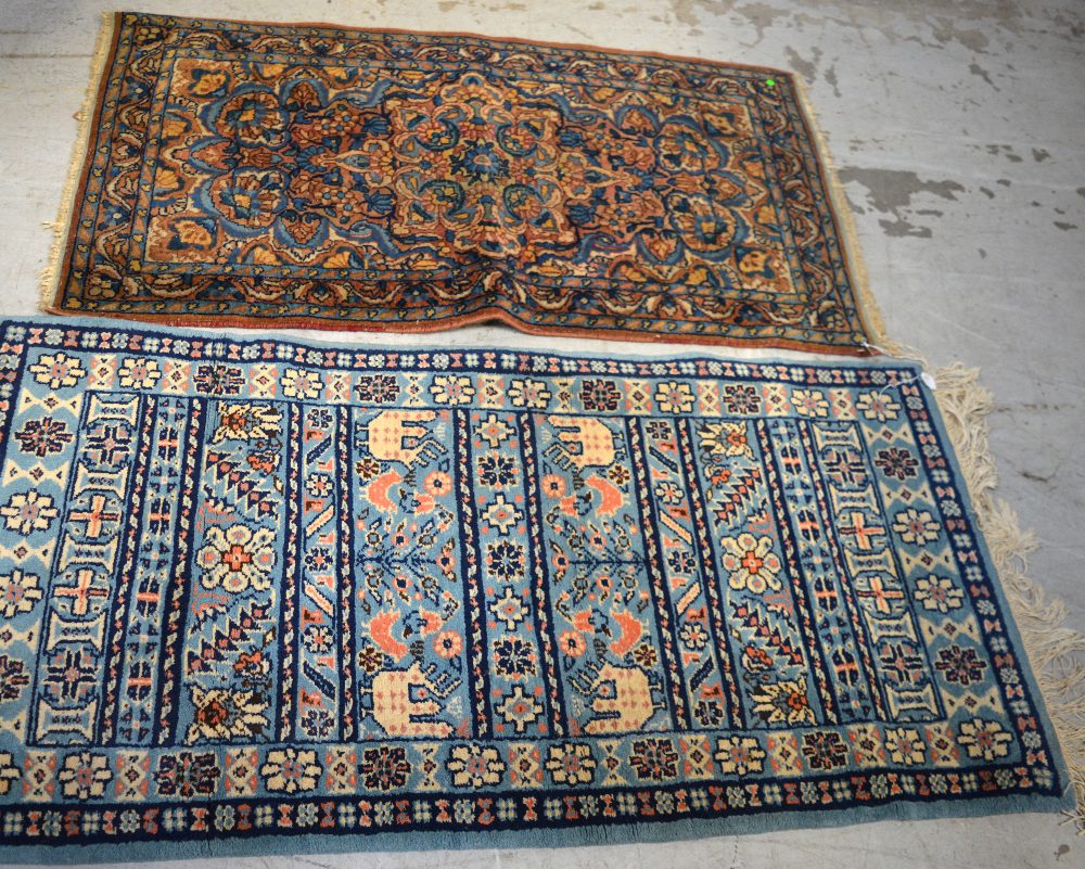 A blue ground Tunisian rug, 141cm x 70cm and an Eastern floral design carpet, 130 x 68cm (2).