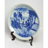 A large Chinese circular charger with figural decoration in blue-over-white ground,