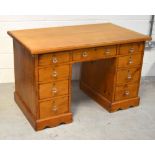 A 20th century pine nine-drawer pedestal desk on plinth base, width 128cm.