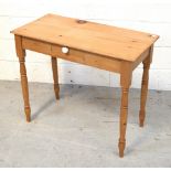 A 20th century pine desk/side table with single drawer on turned legs, width 84cm.