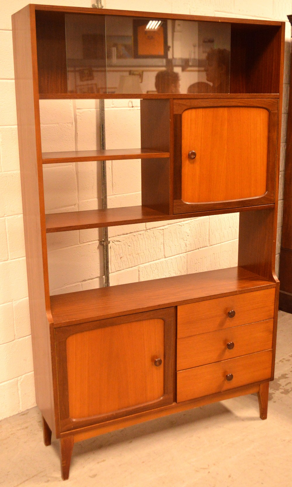 A G-Plan style teak unit/dresser, raised on tapering supports, width 107cm.