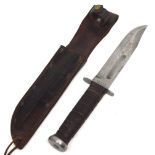 A 20th century KA-BAR Olean, N.Y. knife in leather scabbard.