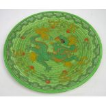 A Charlotte Rhead Crown Ducal tube lined mottled green ground Oriental inspired charger,