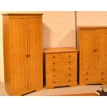 A modern pine bedroom suite comprising twin-door wardrobe, width 79cm, a smaller tallboy,