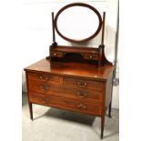 An Edwardian inlaid mahogany oval mirror back dressing table,