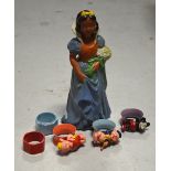 An original terracotta painted figurine of Snow white and five c1950s napkin rings,