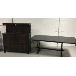 An Ercol style refectory table raised on twin end slab supports,