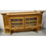 A 20th century pine dresser top/unit with two astragal glazed doors with integral shelving,