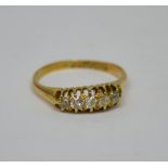 A gold band set with pink and blue stones, unmarked, size H, approx 5.6g.