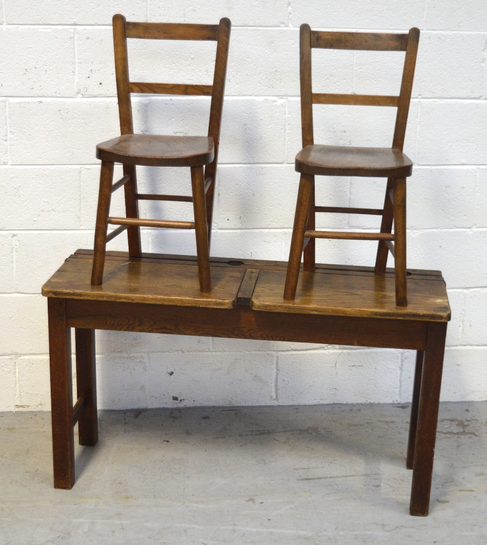 A vintage child's double school desk, width 102cm and a pair of matching ladder back chairs (3).