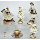 Four 20th century Dresden and Dresden style figures of ladies in lace dresses to include a seated