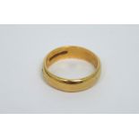 A 22ct yellow gold band, size L, approx 6.1g.