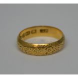 An 18ct yellow gold band, size L, approx 3.1g (af).