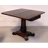 A Regency rosewood fold-over pedestal tea table raised on a quatrefoil base,