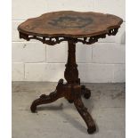 An Italian walnut and inlaid table decorated with hunting scene to the top on heavily carved tripod