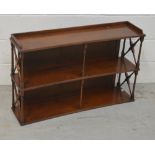 A mahogany two-tier bookshelf for wall mounting with cross banded stretchers, width 91cm.