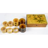 A set of four various tartan ware napkin rings, a set of three ivorine numbered examples,