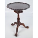A mid 20th century miniature mahogany bird cage action table with piecrust rim above fluted and