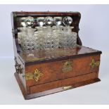 A Victorian figured walnut tantalus/smoking compendium,