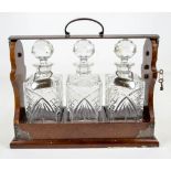 An Edwardian mahogany and electroplated tantalus by P B S,