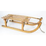 A vintage wooden sledge with metal trim.