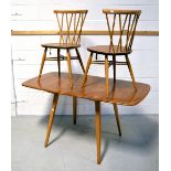 A retro Ercol extending dining table on outstretched square section legs,