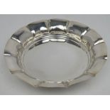 A George VI hallmarked silver bowl with petal-shaped rim, raised on three outstretched feet,